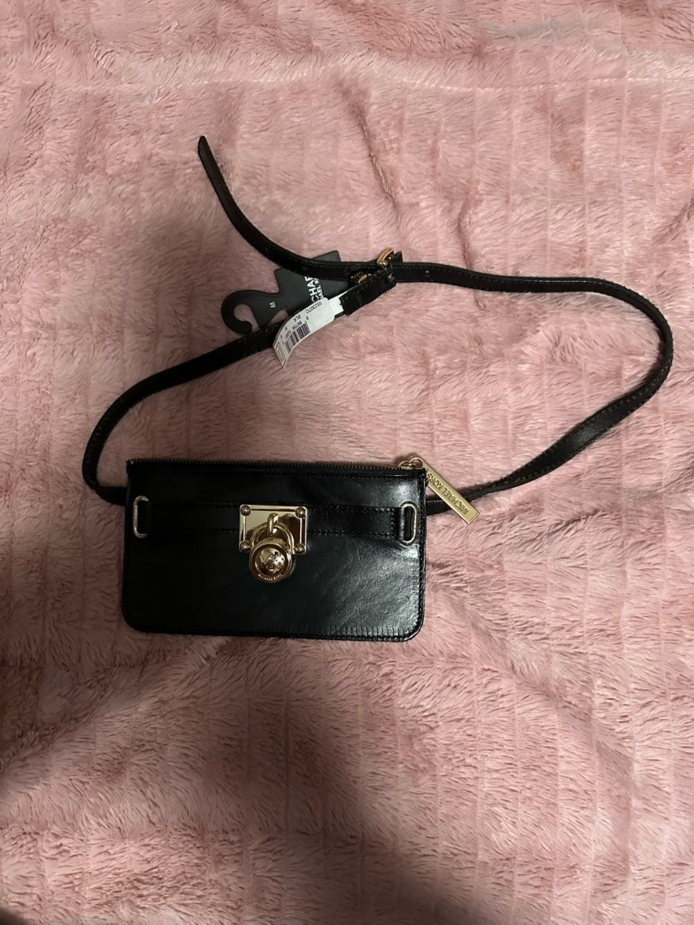 Michael Kors Black Leather fanny pack with Gold Hardware. Worn around the waist.